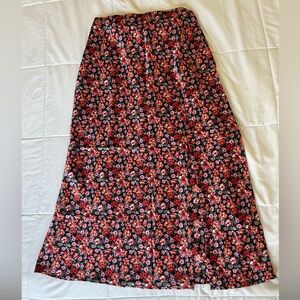 Fancesca’s midi skirt with slit on left leg. Runs true to size.